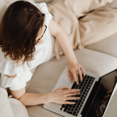 Adult typing on a computer